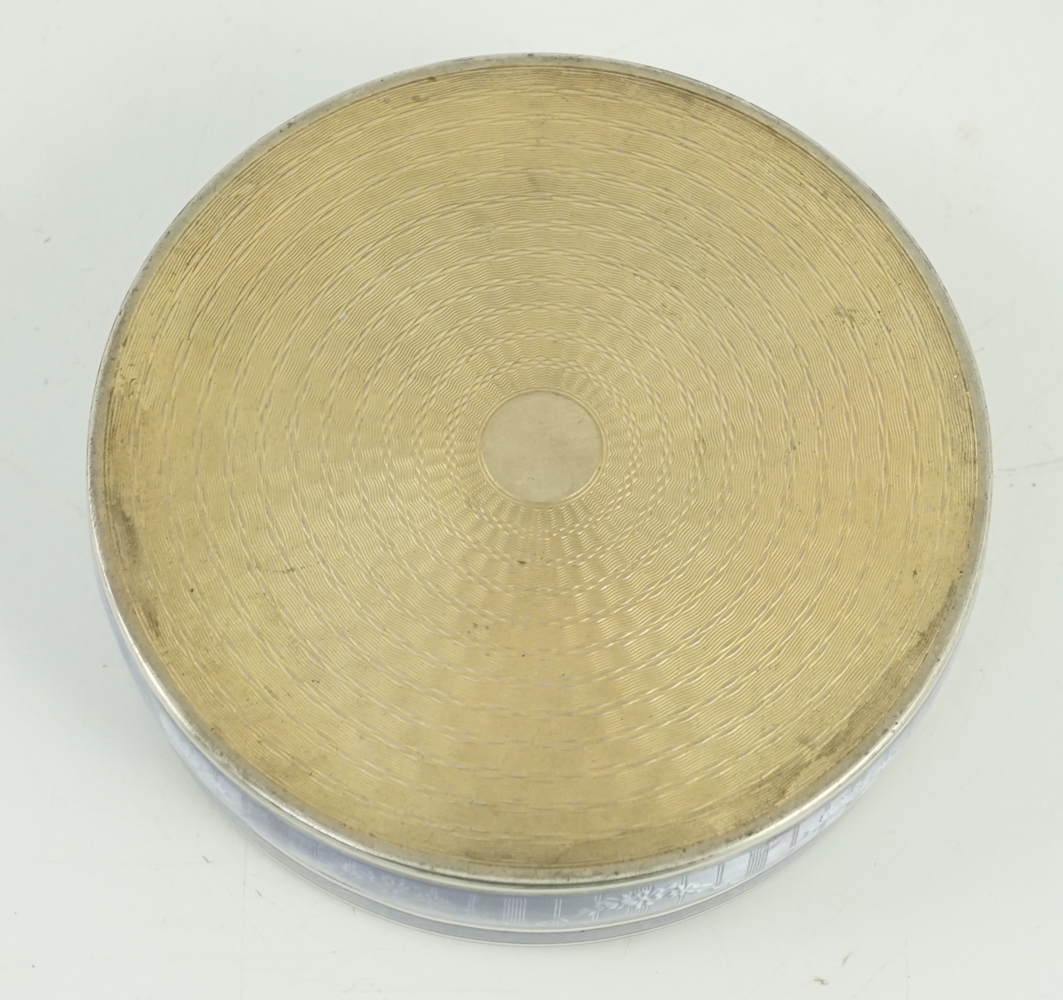 A 19th century French part engine turned silver and guilloche enamelled circular box and cover